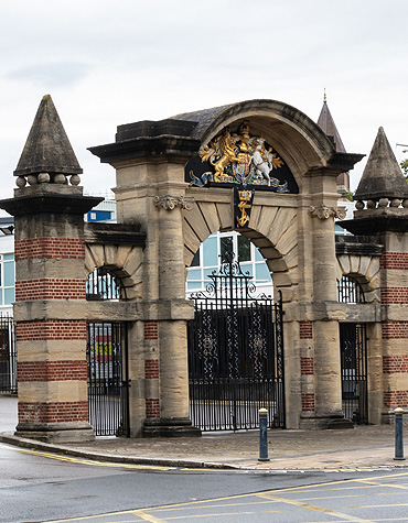 The main gate to HMS Nelson. Portsmouth Naval Base's architecture blends historical fortification brickwork and modern naval infrastructure.