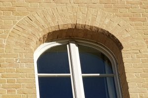 Structural brick window arches, created by Apex BrickCutters, at Peterhouse College, where the windows are set back from the brickwork.