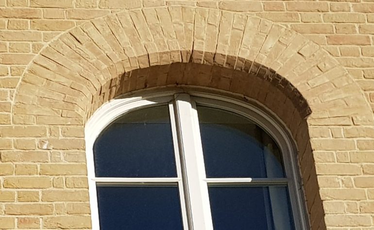 Structural brick window arches, created by Apex BrickCutters, at Peterhouse College, where the windows are set back from the brickwork.