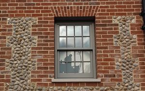 An example of an Apex BrickCutters Traditional FG2 brick window arch with brick soffits. The windows are set back from the brickwork, showing a check reveal detail.