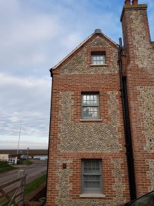 A Norfolk house using Apex BrickCutters Traditional FG2 brick arches with brick soffits as the windows are set back from the brickwork, showing a check reveal detail.