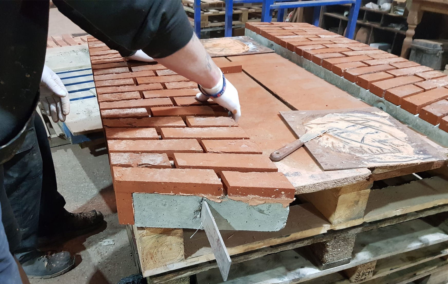 Construction of a pre-formed structural brick arch, a ready-made unit designed for quick installation, with brick slips set into a rigid framework for support.