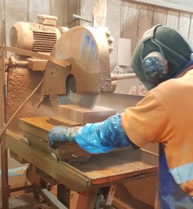 An Apex BrickCutters employee uses diamond-tipped blades and water to cut full clay bricks and produce special shaped bricks with two-part epoxy resign, specifically developed for this task.