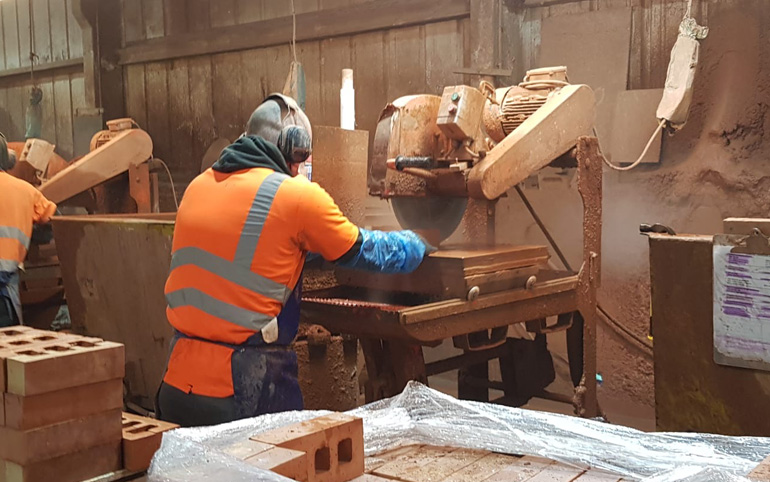 Members of the Apex BrickCutters team at work in the factory, creating brick slips.